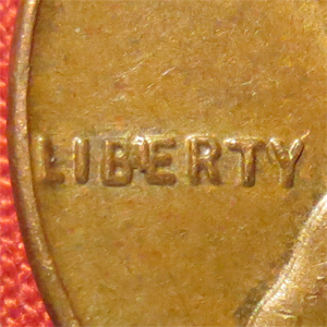 1985 Lincoln penny BIE die crack showing raised vertical line between B and E in LIBERTY